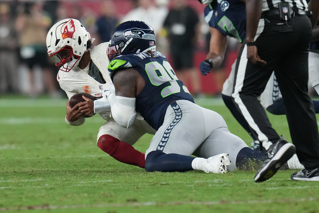 Seattle Seahawks defensive end Leonard Williams (99) sacks Arizona Cardinals quarterback Kyler Murray during the first half of an NFL football game Thursday, Sept. 25, 2025, in Glendale, Ariz. (AP Photo/Rick Scuteri)