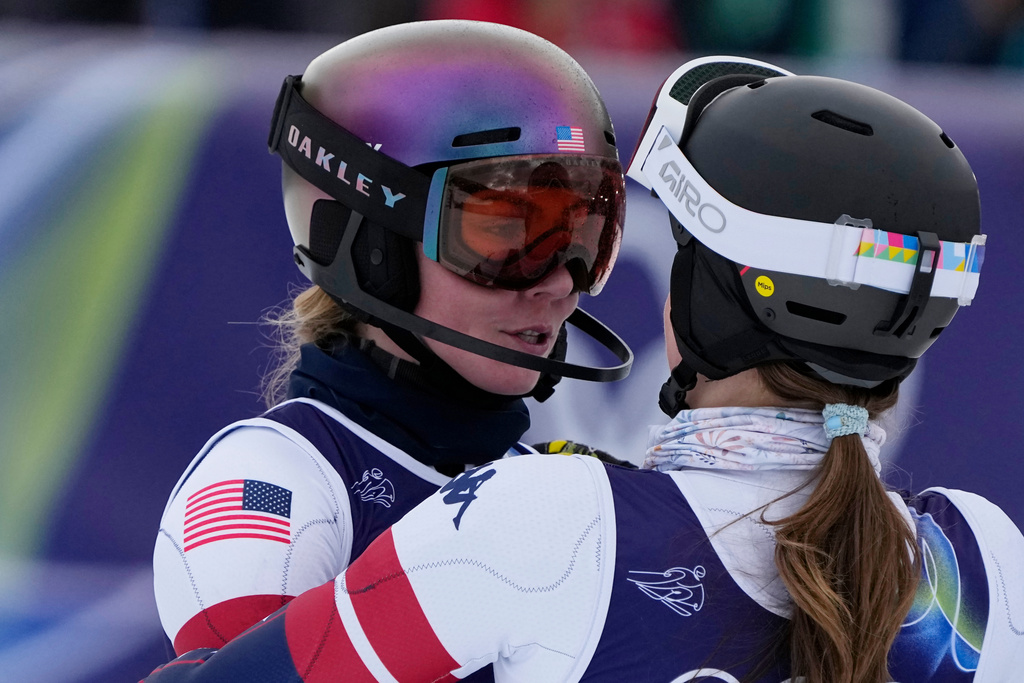 United States' Mikaela Shiffrin, left, is hugged by United States' Paula Moltzan at the finish area of an alpine ski, women's team combined race, at the 2026 Winter Olympics, in Cortina d'Ampezzo, Italy, Tuesday, Feb. 10, 2026. (AP Photo/Andy Wong)