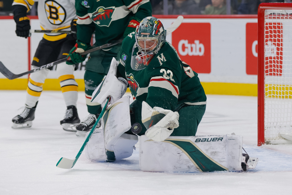 Minnesota Wild goaltender Filip Gustavsson (32) makes a glove-save during the first period of an NHL hockey game against the Boston Bruins, Sunday, Dec. 14, 2025, in St. Paul, Minn. (AP Photo/Bailey Hillesheim)