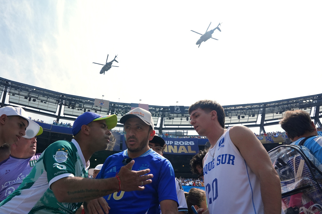 The Marine One helicopter carrying President Donald Trump, and an escort helicopter, fly over the stadium before the start of the World Cup championship final soccer match between Spain and Argentina, in East Rutherford, N.J., Sunday, July 19, 2026. (AP Photo/Jacquelyn Martin)