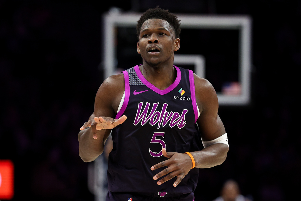 Minnesota Timberwolves guard Anthony Edwards (5) celebrates his 3-point basket against the Golden State Warriors during the first half of an NBA basketball game Sunday, Jan. 25, 2026, in Minneapolis. (AP Photo/Matt Krohn)
