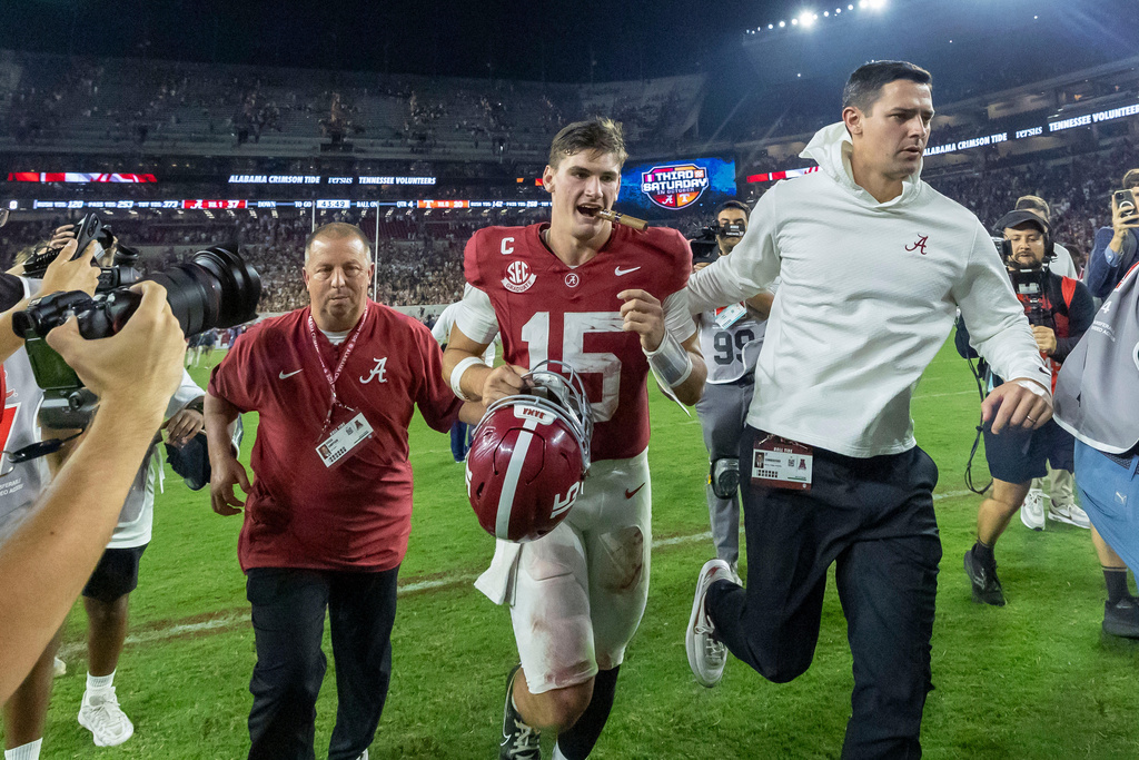 Alabama quarterback Ty Simpson (15) departs the field, with a victory cigar, after Alabama's 37-20 win over Tennessee at an NCAA college football game, Saturday, Oct. 18, 2025, in Tuscaloosa, Ala. Cigars are a tradition for the victor of the Tennessee-Alabama game. (AP Photo/Vasha Hunt)