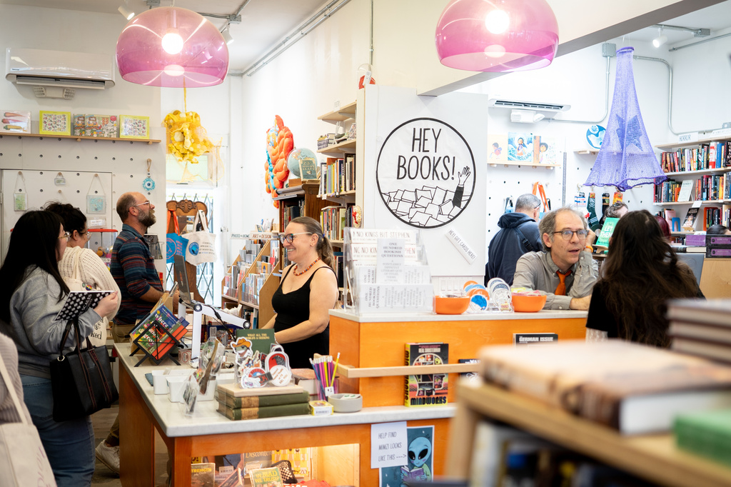 Co-owners Anika Omark, lcenter eft, and Matthew Hein, center right, appear behind the counter at their bookstore, Hey Books!, in San Diego on April 26, 2026. (Rachyel P. Magaña/Hey books! via AP)