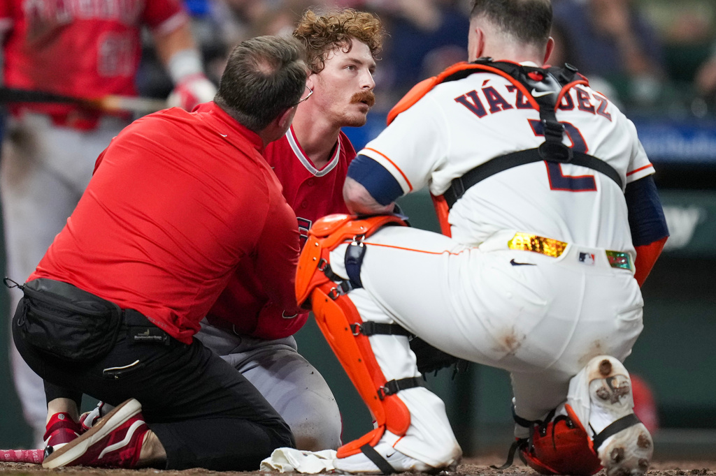 Los Angeles Angels' Wade Meckler, center, is looked at by a trainer, left, and Houston Astros catcher Christian Vázquez (2) after being hit in the head by a pitch during the fifth inning of a baseball game Thursday, Aug. 20, 2026, in Houston. (AP Photo/Eric Christian Smith)
