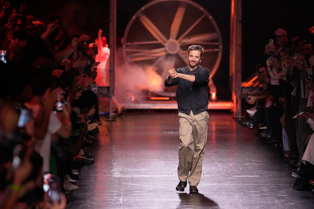 Designer Glenn Martens accepts applause after his Diesel women's Spring-Summer 2027 collection presented in Milan, Italy, Tuesday, Sept. 22, 2026. (AP Photo/Luca Bruno).