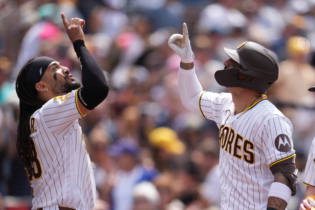 San Diego Padres' Nick Castellanos, right, celebrates with teammate Fernando Tatis Jr. after hitting a two-run home run during the fifth inning of a baseball game against the Chicago Cubs Wednesday, April 29, 2026, in San Diego. (AP Photo/Gregory Bull)