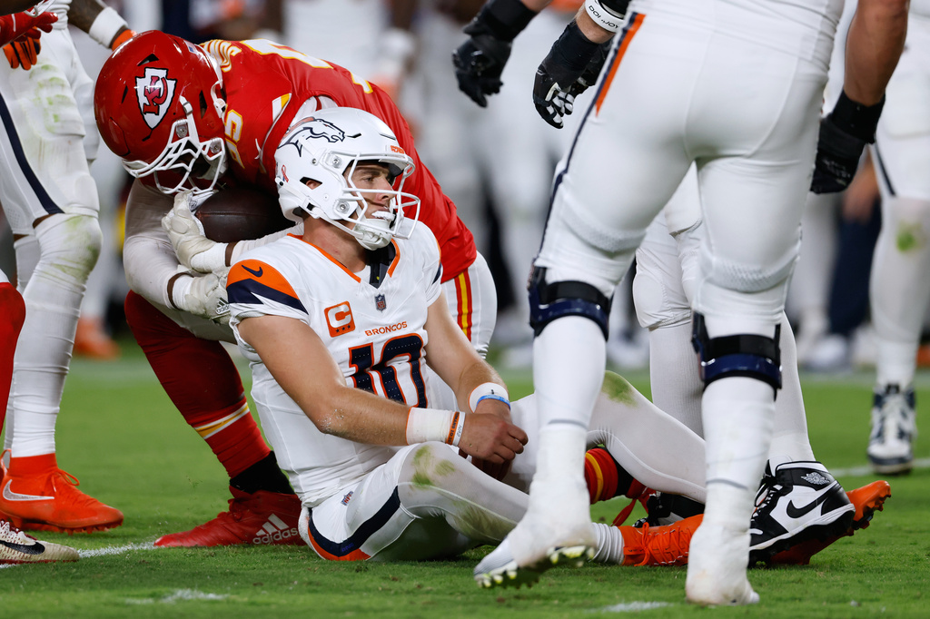 Kansas City Chiefs defensive end Chris Jones, left, holds the football after Denver Broncos quarterback Bo Nix (10) fumbled it during the second half of an NFL football game Monday, Sept. 14, 2026, in Kansas City, Mo. (AP Photo/Colin E. Braley)