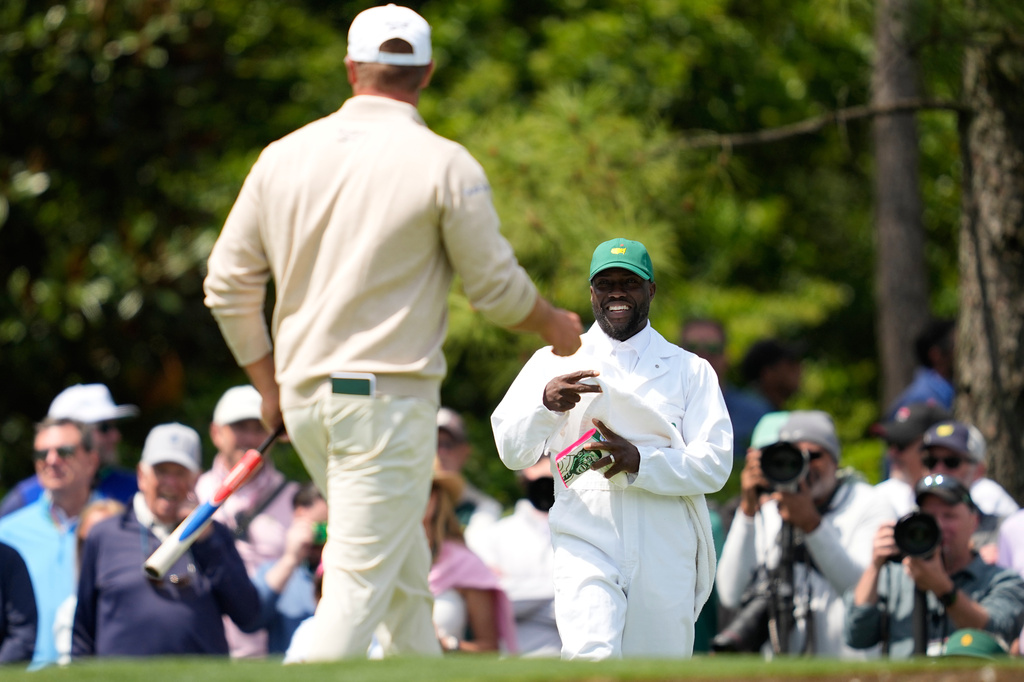 Actor Kevin Hart, right, smiles as Bryson DeChambeau on the second hole during par-3 contest ahead of the Masters golf tournament at the Augusta National Golf Club, Wednesday, April 8, 2026, in Augusta, Ga. (AP Photo/Ashley Landis)