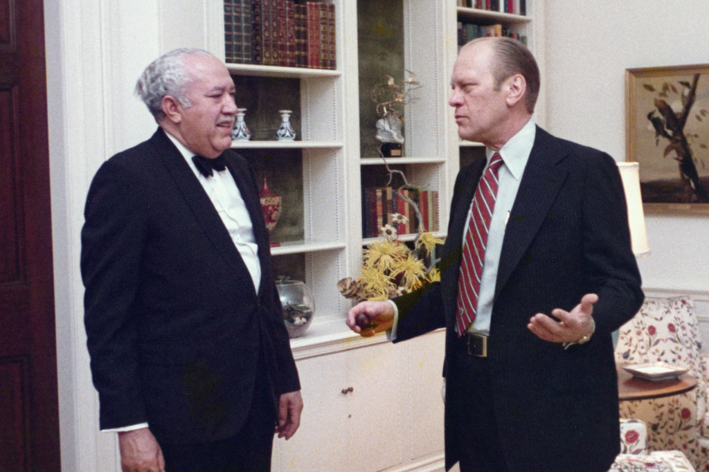 In this 1975 photo provided by The White House, President Gerald Ford speaks with John Woodson Ficklin in the residence of the White House in Washington. (White House Historical Association/The White House via AP)