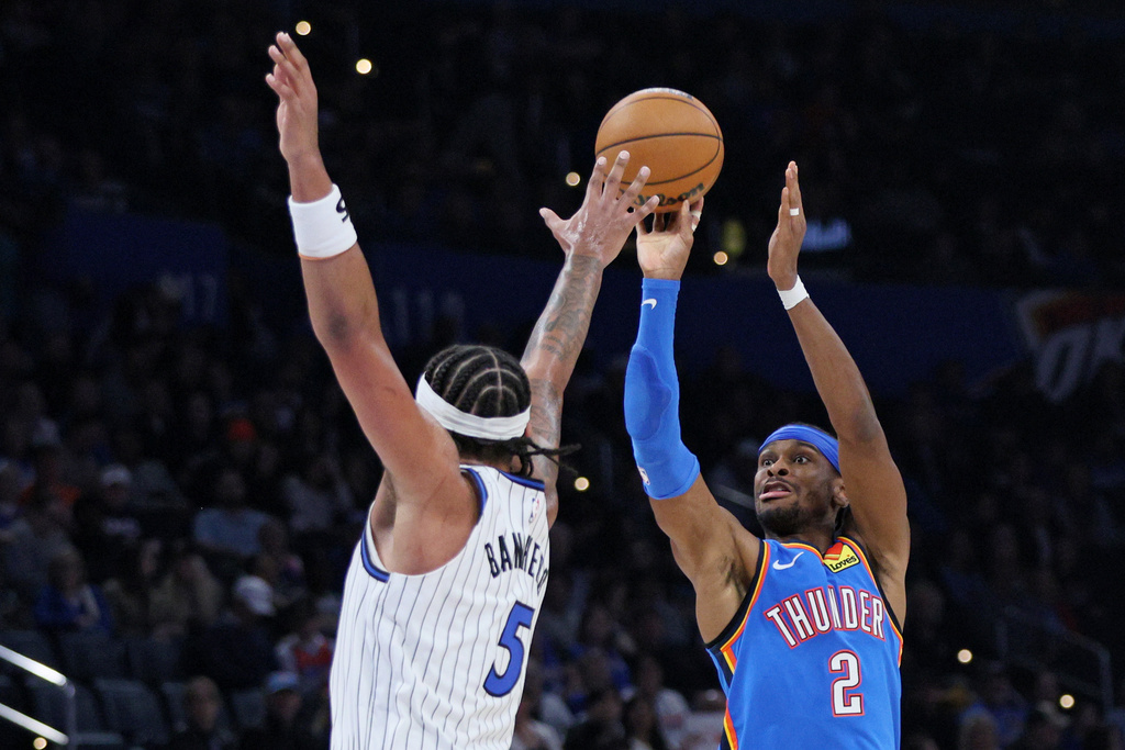 Oklahoma City Thunder guard Shai Gilgeous-Alexander (2) looks to shoot over Orlando Magic forward Paolo Banchero (5) during the second half of an NBA basketball game Tuesday, Feb. 3, 2026, in Oklahoma City. (AP Photo/Nate Billings)