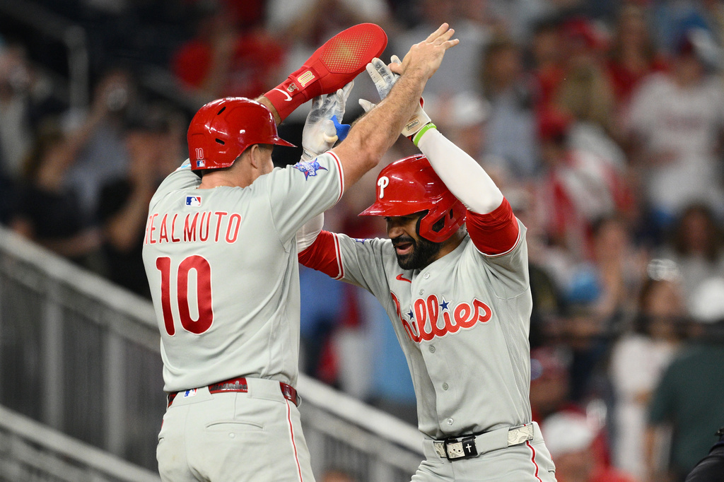 Philadelphia Phillies' Derek Hill, right, celebrates his two-run home run with J.T. Realmuto, left, during the ninth inning of a baseball game against the Washington Nationals, Thursday, June 25, 2026, in Washington. (AP Photo/Nick Wass)
