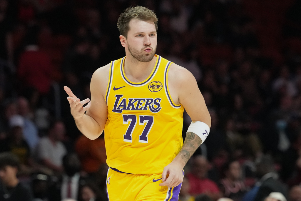 Los Angeles Lakers guard Luka Doncic (77) reacts after scoring during the second half of an NBA basketball game against the Miami Heat, Thursday, March 19, 2026, in Miami. (AP Photo/Lynne Sladky)