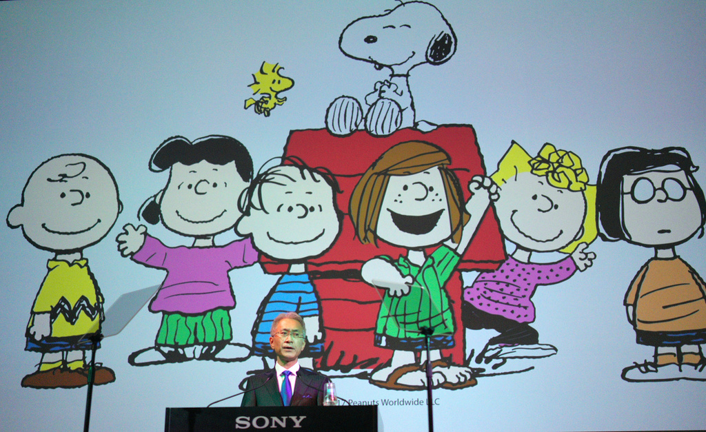 FILE - Sony Corp. President Kenichiro Yoshida speaks as characters from Peanuts are shown at a press conference at the company's headquarters Tuesday, May 22, 2018, in Tokyo. (AP Photo/Eugene Hoshiko, File)