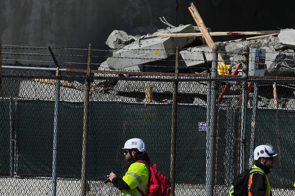 First responders inspect a partially collapsed parking garage in Philadelphia, Thursday, April 9, 2026. (AP Photo/Matt Rourke)