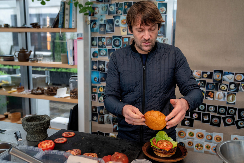 Noma's chef René Redzepi prepares a vegetarian burger in a restaurant, in Copenhagen, Nov. 24, 2024. (Soeren Bidstrup/Ritzau Scanpix via AP)