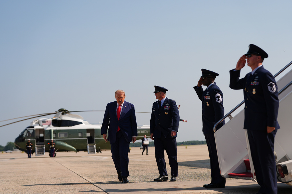 President Donald Trump, left, is escorted by Air Force Col. Christopher M. Robinson, Commander, 89th Airlift Wing, right, from Marine One to Air Force One, Wednesday, July 22, 2026, at Joint Base Andrews, Md. (AP Photo/Julia Demaree Nikhinson)