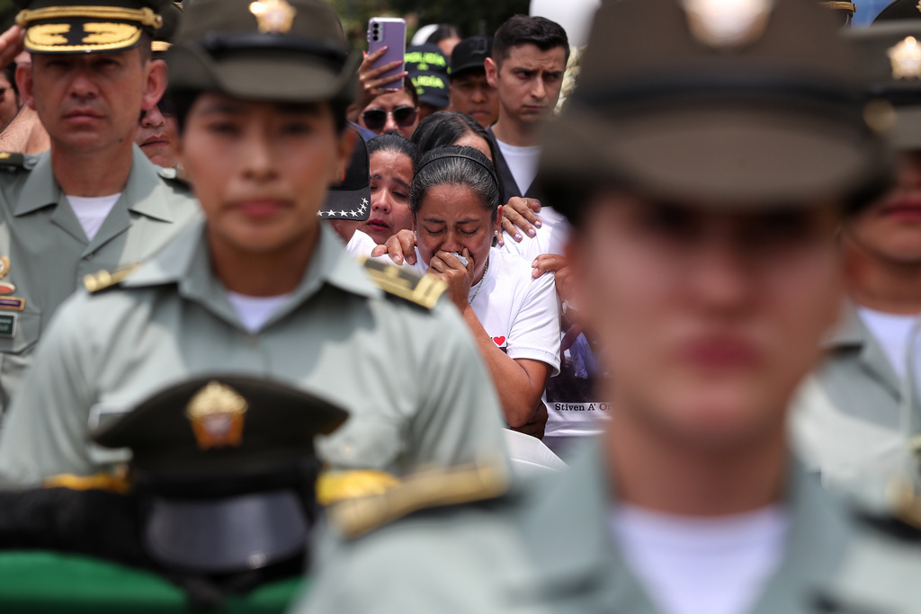 Maria Isabel Ortiz mourns during the funeral of her son, Michael Astaiza, a police officer killed when a police helicopter was shot down by a dissident faction of the former FARC guerrilla group, in Cali, Colombia, Monday, Aug. 25, 2025. (AP Photo/Santiago Saldarriaga)