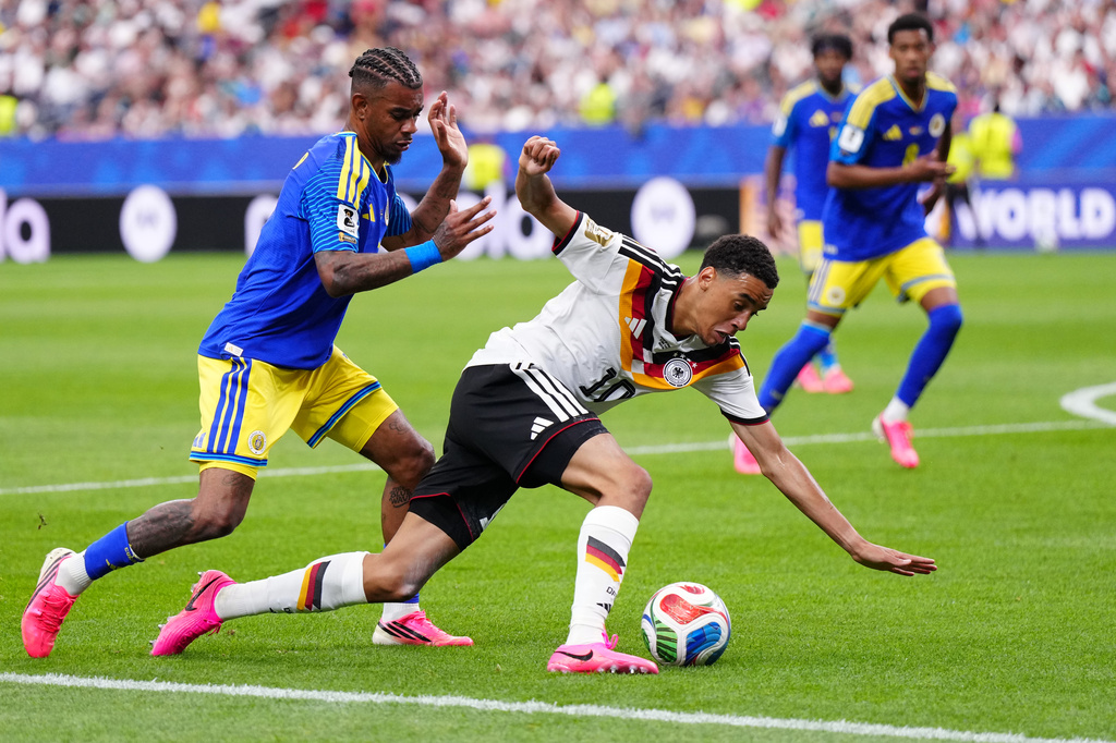 Germany's Jamal Musiala falls to the ground in front of Curaçao's Juninho Bacuna during the World Cup Group E soccer match between Germany and Curacao in Houston, Sunday, June 14, 2026. (AP Photo/Karen Warren)