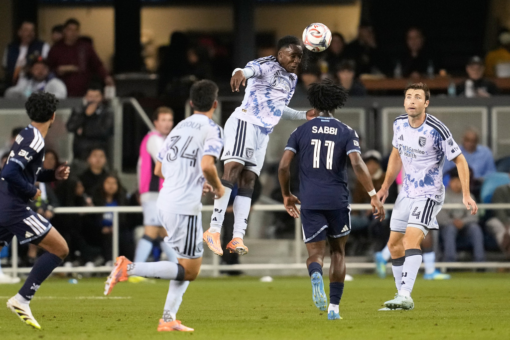San Jose Earthquakes midfielder Jamar Ricketts, middle, jumps for the ball against the Vancouver Whitecaps during the second half of an MLS soccer match Saturday, May 9, 2026, in San Jose, Calif. (AP Photo/Jeff Chiu)