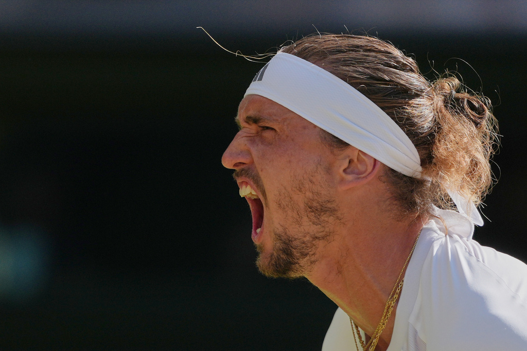 Alexander Zverev of Germany celebrates after winning the first set against Jannik Sinner of Italy during the men's singles final at Wimbledon Tennis Championships in London, Sunday, July 12, 2026. (AP Photo/Kin Cheung)