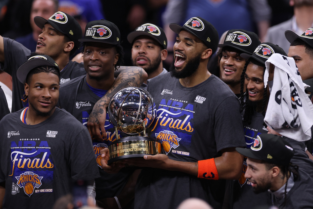 The New York Knicks hold the Eastern Conference Championship trophy after Game 4 in the Eastern Conference finals NBA basketball playoffs series against the Cleveland Cavaliers in Cleveland, Monday, May 25, 2026. (AP Photo/Tim Phillis)