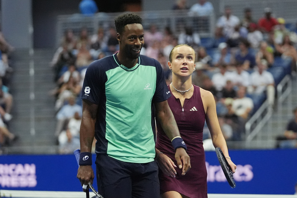 Elina Svitolina, of Ukraine, and Gael Monfils, left, of France, react while competing against Belinda Bencic, of Switzerland, and Flavio Cobolli, of Italy, during a mixed doubles semifinal match at the U.S. Open tennis championships Wednesday, Aug. 26, 2026, in New York. (AP Photo/Frank Franklin II)