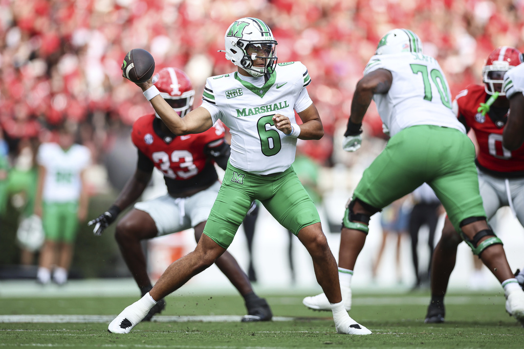 Marshall quarterback JacQai Long (6) throws a pass during the first half of an NCAA college football game against Georgia, Saturday, Aug. 30, 2025, in Athens, Ga. (AP Photo/Colin Hubbard)