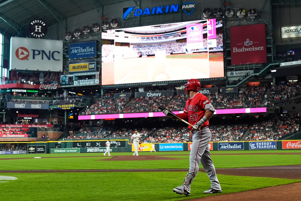 Los Angeles Angels designated hitter Mike Trout reacts after striking out as the ABS replay shows on the screen during the first inning of a baseball game against the Houston Astros in Houston, Sunday, March 29, 2026. (AP Photo/Ashley Landis)