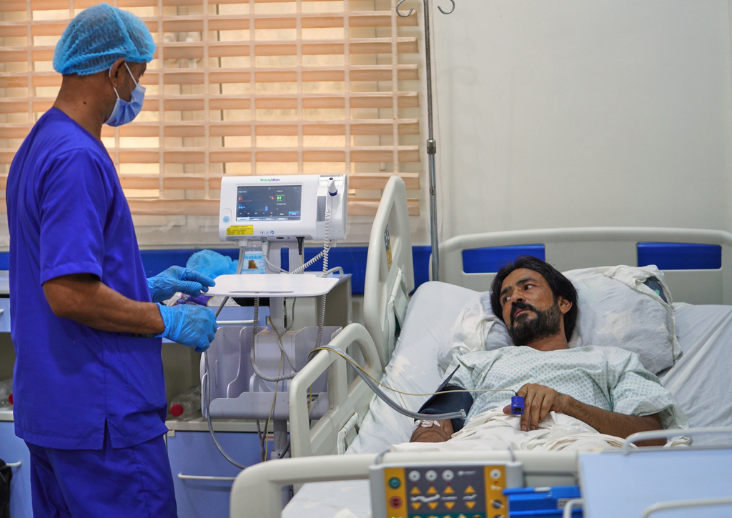 Pakistani crew member Zaheer Ahmed, right, receives medical treatment at 2 December Hospital in Mokha, Yemen, Wednesday, Aug. 12, 2026, after the cargo ship Tihama was struck in a Houthi attack in the Bab al-Mandab Strait off Yemen's Dhubab district on Aug. 10, 2026. (AP Photo/Abdulnasser Alseddik)