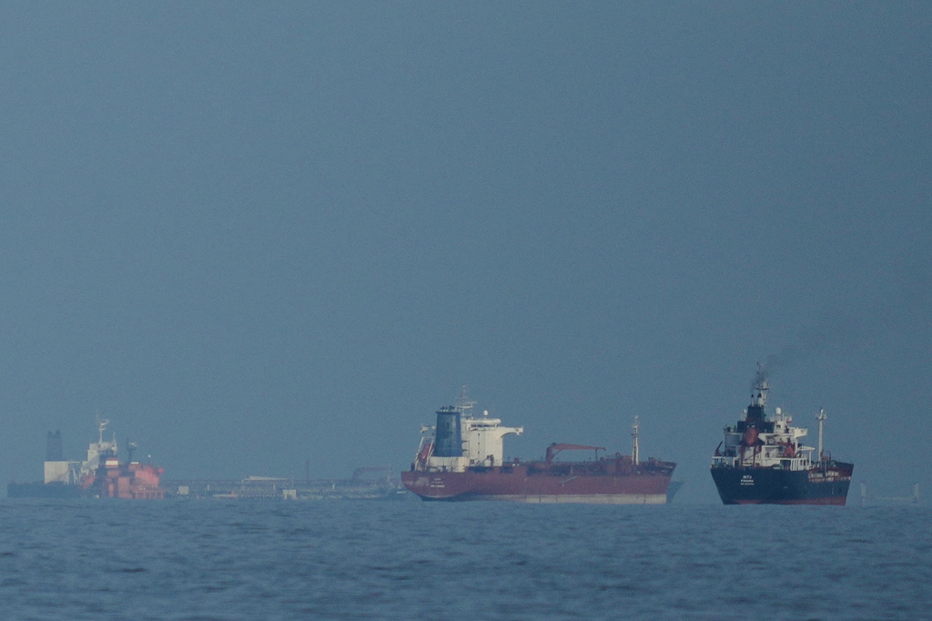 FILE - Oil tankers and cargo ships line up in the Strait of Hormuz as seen from Khor Fakkan, United Arab Emirates, Wednesday, March 11, 2026. (AP Photo/Altaf Qadri,File)