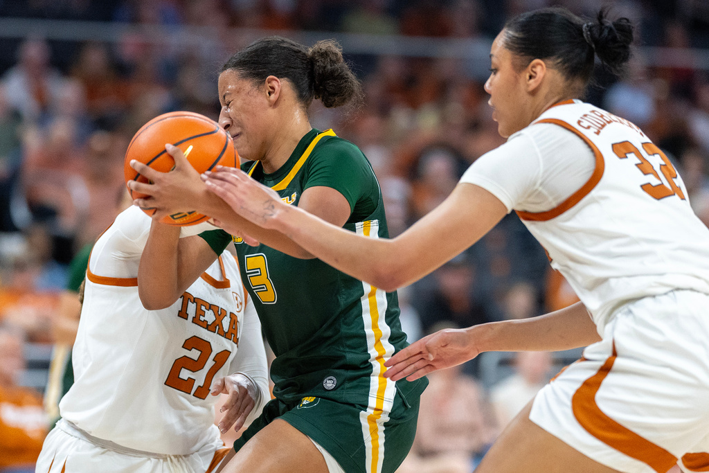 Southeastern Louisiana guard Eryn McKinzie (3) is defended by Texas guard Ashton Judd (21) and forward Teya Sidberry (32) during the first half of an NCAA college basketball game Sunday, Dec. 28, 2025, in Austin, Texas. (AP Photo/Stephen Spillman)