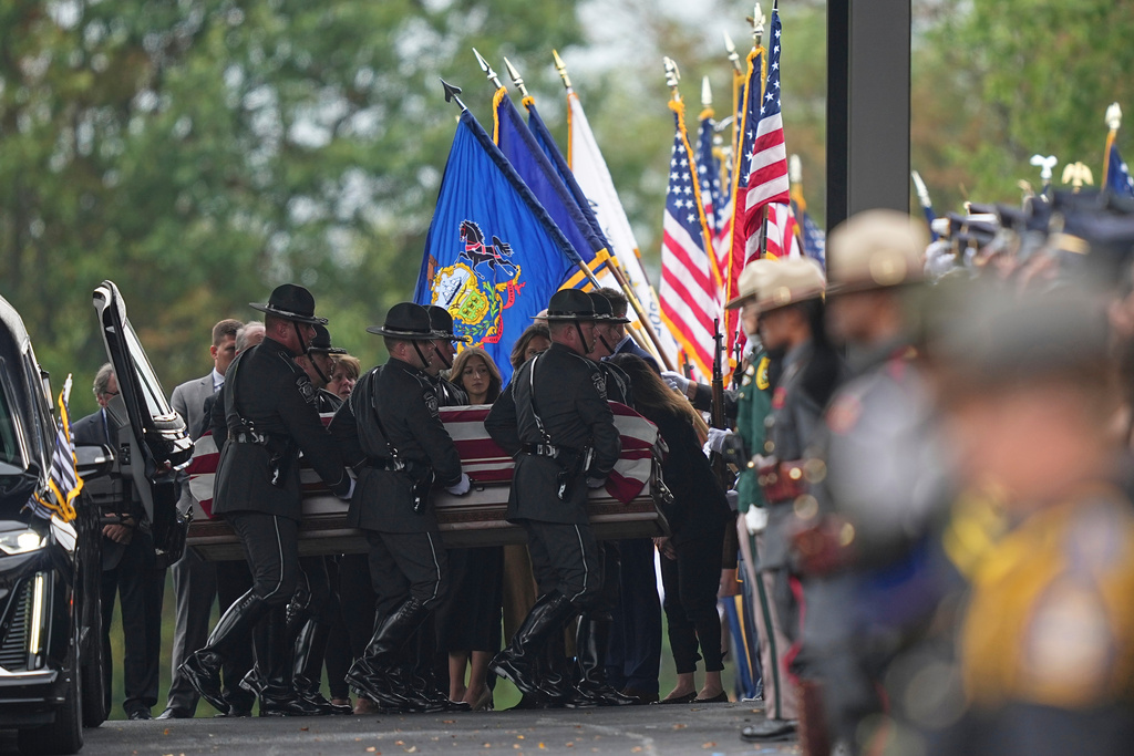Pall bearers carry the coffin of a slain officer during funeral services for Northern York County Regional Police detectives Cody Michael Becker, Mark Edward Baker and Isaiah Emenheiser, Thursday, Sept. 25, 2025, in Red Lion, Pa. (AP Photo/Matt Rourke)