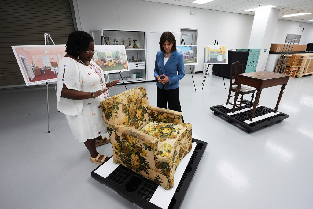 FILE - Amber N. Mitchell, Curator of Black History, left, and Patricia Mooradian, President and CEO of The Henry Ford, right, view items from the Jackson House, where Martin Luther King Jr. and others planned marches to call for Black voting rights in the early 60s in Selma, Ala., at The Henry Ford in Dearborn, Mich., July 14, 2025. (AP Photo/Paul Sancya, File)