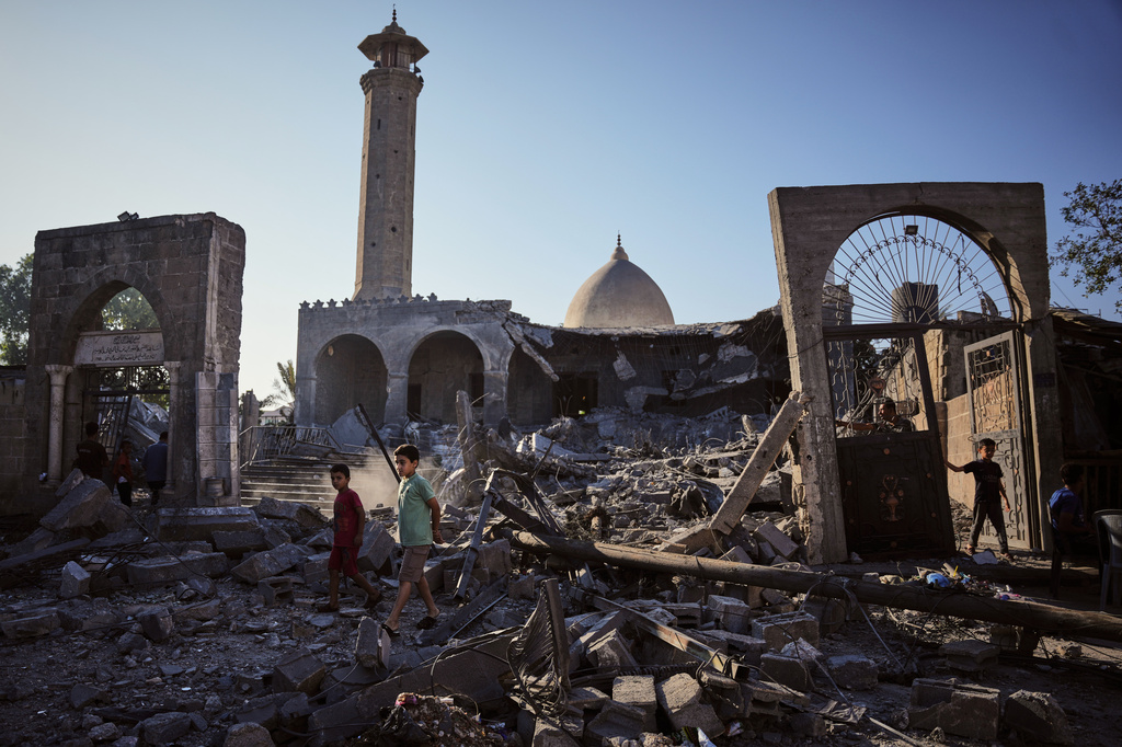 Palestinians inspect the Abu Salim Mosque a day after it was hit by an Israeli airstrike, in Deir al-Balah, central Gaza Strip, Tuesday, Aug. 25, 2026. (AP Photo/Abdel Kareem Hana)
