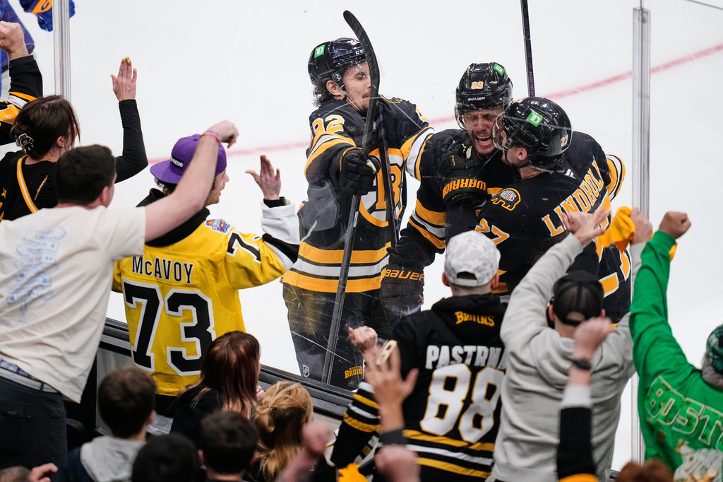 Boston Bruins right wing David Pastrnak, center, is congratulated after his goal during the second period in Game 6 of a first-round NHL hockey Stanley Cup playoff series against the Buffalo Sabres, Friday, May 1, 2026, in Boston. (AP Photo/Charles Krupa)