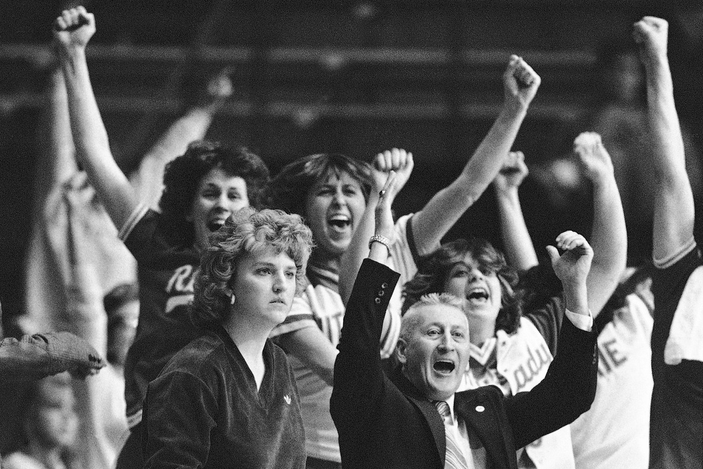 FILE - Rutgers coach Theresa Shank Grentz, front left, looks on as members of her women's basketball team leap from the bench in the final seconds of their win over Texas in the AIAW national basketball championship, Sunday, March 28, 1982 in Philadelphia. (AP Photo/Rusty Kennedy, File)