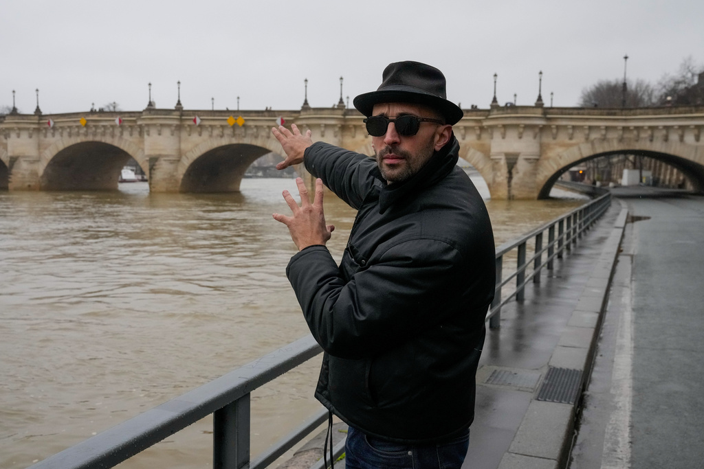 French artist JR gestures during an interview with the Associated Press next to the Pont Neuf bridge about his project called Pont Neuf Cavern, in Paris, France, Wednesday, Feb. 18, 2026. (AP Photo/Michel Euler)