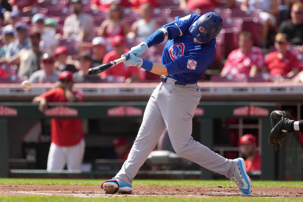 Chicago Cubs' Ian Happ hits a double during the first inning of a baseball game against the Cincinnati Reds, Sunday, Sept. 20, 2026, in Cincinnati. (AP Photo/Kareem Elgazzar)