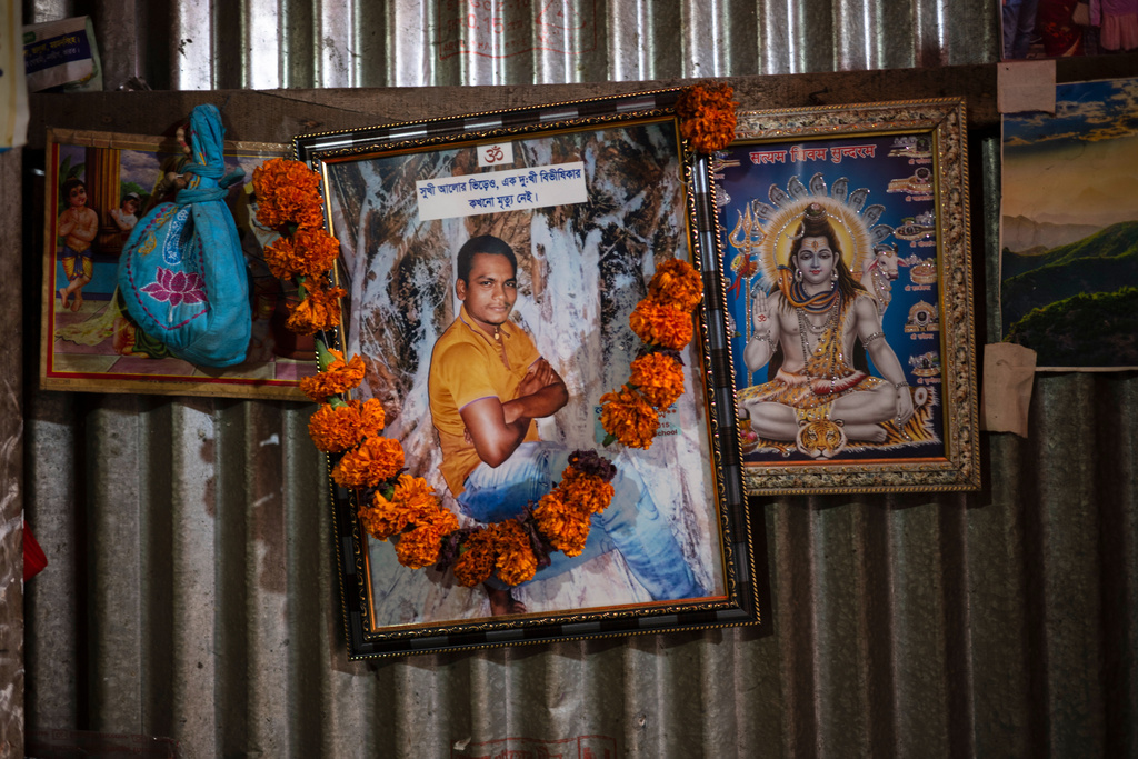 A portrait of Dipu Chandra Das hangs alongside images of Hindu deities inside his home in Tarakanda village, Mymensingh District, Bangladesh, Jan. 9, 2026. (AP Photo/Mahmud Hossain Opu)