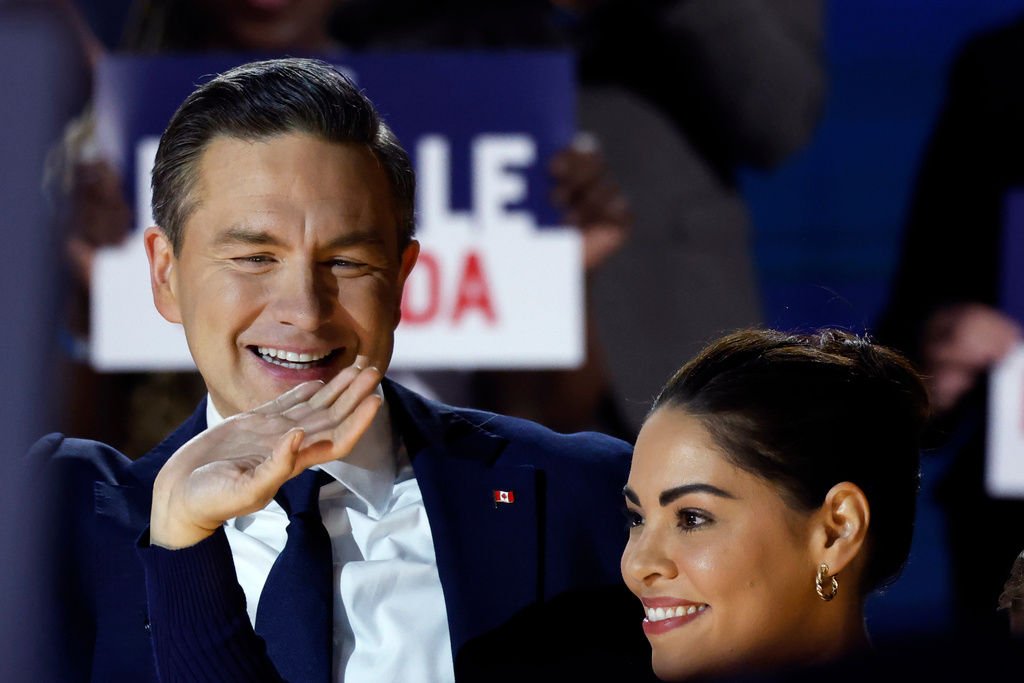 Conservative Party Leader Pierre Poilievre, and wife Anaida arrive at the podium as he prepares to deliver his keynote address at the party's national convention in Calgary, Friday, Jan. 30, 2026. (Larry MacDougal /The Canadian Press via AP)