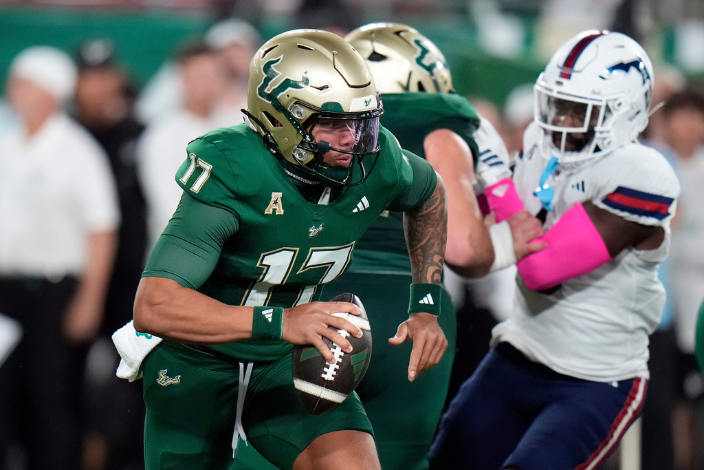 South Florida Bulls quarterback Byrum Brown (17) scrambles for yardage against Florida Atlantic during the first half of an NCAA college football game Saturday, Oct. 18, 2025, in Tampa, Fla. (AP Photo/Chris O'Meara)