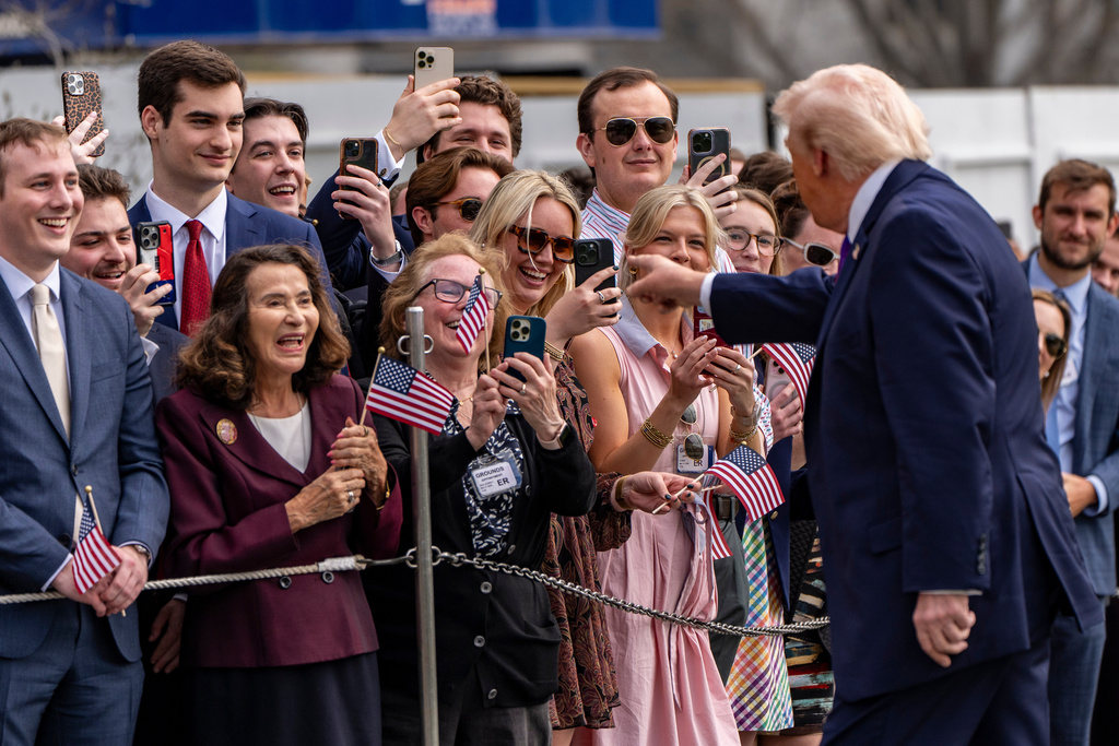 President Donald Trump greets supporters before departing on Marine One from the South Lawn of the White House, Wednesday, March 11, 2026, in Washington. (AP Photo/Alex Brandon)