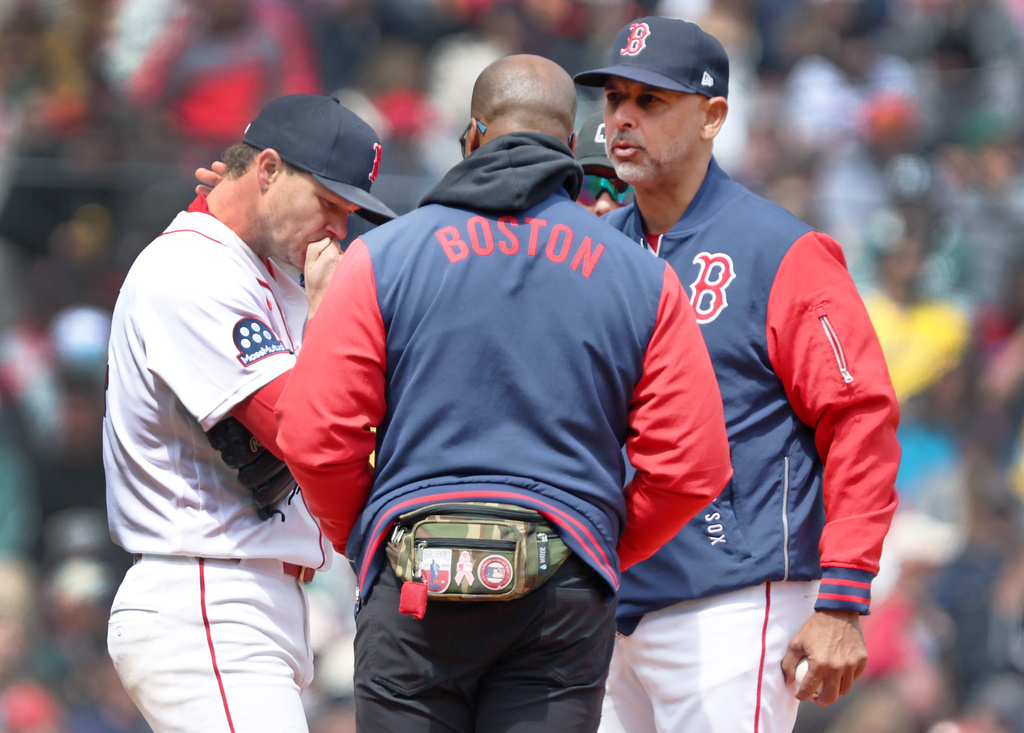 Boston Red Sox' starting pitcher Sonny Gray, left, is visited on the mound by manager Alex Cora, right, during a baseball game against the Detroit Tigers, Monday, April 20, 2026 in Boston. (AP Photo/Jim Davis)