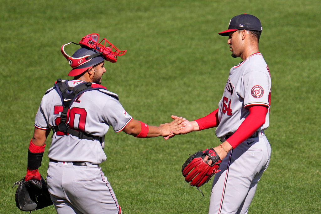 Washington Nationals pitcher Orlando Ribaita, right, celebrates with catcher Keibert Ruiz after getting the final out of a baseball game against the Pittsburgh Pirates in Pittsburgh, Thursday, April 16, 2026. (AP Photo/Gene J. Puskar)