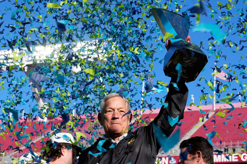 Iowa head coach Kirk Ferentz holds up the trophy after winning the ReliaQuest Bowl NCAA college football game against Vanderbilt Wednesday, Dec. 31, 2025, in Tampa, Fla. (AP Photo/Chris O'Meara)