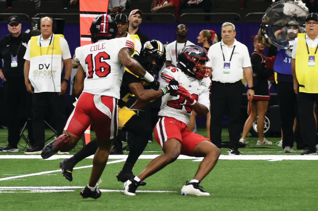 Southern Mississippi wide receiver Tychaun Chapman (2) catches a ball between Western Kentucky defenders during the first half of the New Orleans Bowl Tuesday, Dec. 23, 2025 in New Orleans, La. (Aimee Cronan/The Gazebo Gazette via AP)