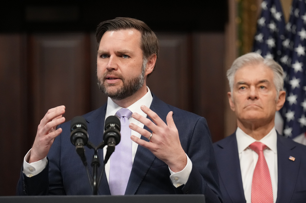 Flanked by Centers for Medicare & Medicaid Services Administrator Dr. Mehmet Oz, right, Vice President JD Vance speaks to the media from the Eisenhower Executive Office Building on the White House campus, Wednesday, May 13, 2026, in Washington. (AP Photo/Jacquelyn Martin)