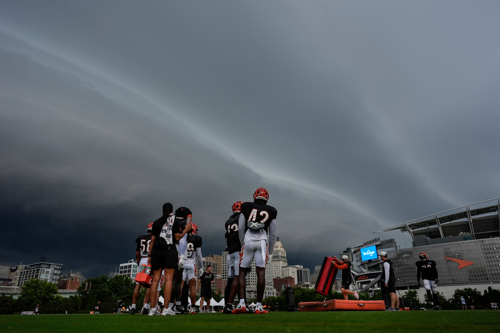 Storm clouds move in from the left during the Cincinnati Bengals' NFL football practice in Cincinnati, Tuesday, Aug. 11, 2026. (AP Photo/Carolyn Kaster)