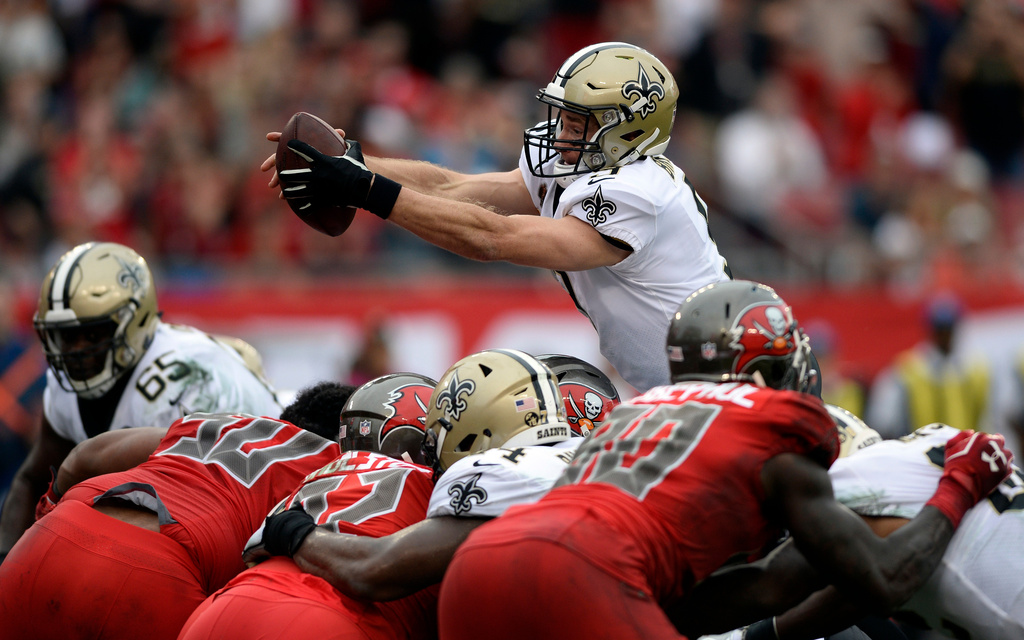 FILE - New Orleans Saints quarterback Drew Brees dives over the line against the Tampa Bay Buccaneers to score on a one-yard touchdown run during the second half of an NFL football game, Dec. 9, 2018, in Tampa, Fla. (AP Photo/Jason Behnken, File)