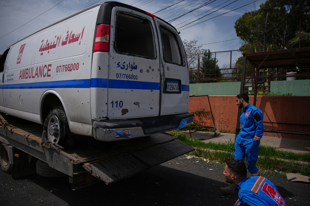Members of Nabatiyeh Emergency Services inspect the damaged ambulance of their colleague who was killed on a rescue mission by an Israeli airstrike on Wednesday, in Nabatiyeh, southern Lebanon, Friday, April 17, 2026. (AP Photo/Hassan Ammar)